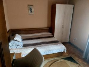 a small room with two beds and a cabinet at Casa Anomis in Călimăneşti