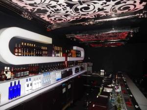 a bar with a lot of bottles of wine at Paris Suites in Festac Town