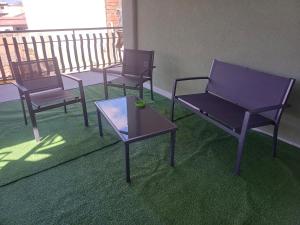 a group of chairs and a table on a balcony at ToNo House in Paterno