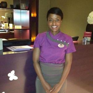 a woman standing in front of a counter at Paris Suites in Festac Town +13 photos