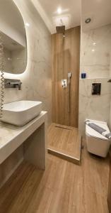 a bathroom with a white sink and a shower at Hotel Avra in Perea