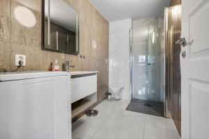 a bathroom with a sink and a shower at Kronborg marina in Averoy +60 photos