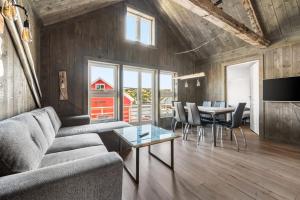 a living room with a couch and a table at Kronborg marina in Averoy