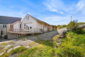 a group of buildings on a dirt road at Kronborg marina in Averoy