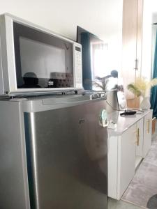 a microwave sitting on top of a refrigerator at Victor Airport suites in Nairobi