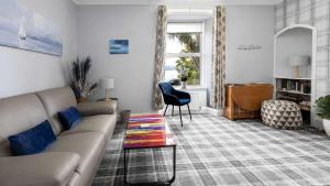 a living room with a couch and a table at Modern Apartment with Garden in Rothesay