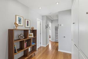 a living room with a book shelf and a hallway at The Eastman House in Santa Cruz