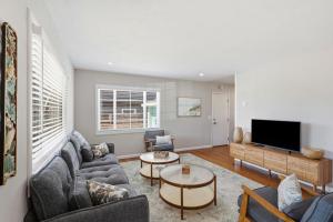 a living room with a couch and a tv at The Eastman House in Santa Cruz