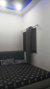 a bedroom with a bed with a black and yellow blanket at Shri Goara palece in Godarpura