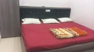 a large bed with a red blanket on it at Shri Goara palece in Godarpura