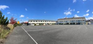 an empty parking lot in front of a building at Super 8 by Wyndham Florence OR in Florence