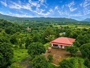 an aerial view of a house in a forest at Attra Farms in Karjat