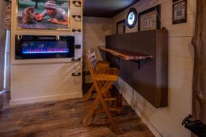 a bar in a tiny house with a fireplace at "The 19th Hole" Luxury Treehouse w Golf Views & Private 20ft Slide - 10 Miles from Dollywood in Sevierville