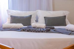 a bed with a blanket and pillows on it at Diamond Hotéis e Flats in São Lourenço
