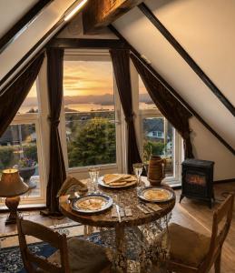 a dining room with a table in front of a window at Fjord Panorama Lodge in Strand +19 photos