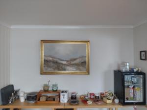 a picture hanging on a wall above a table at Hardanger Rom & Harmonium "The Green B&B" in Herand