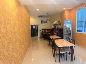 a dining room with tables and chairs in a restaurant at Welcome Suites in Pattaya South