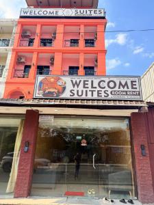 a store front of a building with a welcome to suite sign at Welcome Suites in Pattaya South