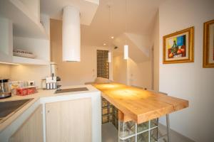 a kitchen with a wooden counter top in a room at DaiRa 103 Luxury Suite sulle Mura di Cefalù in Cefalù
