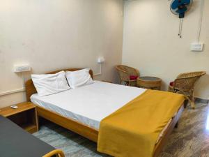 a small room with a bed and chairs in it at Mangrove Village Inn in Kāsarkod