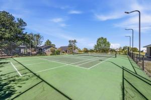 a tennis court with two tennis courts at Escape at the SK in Huntsville