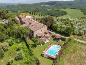 an aerial view of a house with a swimming pool at Countryhouse in Tuscany in Chianni