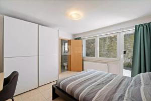 a bedroom with a bed and a bathroom at Centerluxfirst in Luxembourg