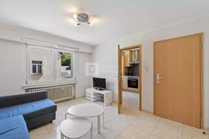 a living room with a couch and a table at Centerluxfirst in Luxembourg