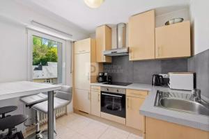 a kitchen with a sink and a counter top at Centerluxfirst in Luxembourg