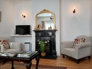 a living room with a fireplace and a mirror at Conways B&B in Claremorris