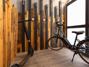 a bike parked in a room next to a broom at ibis Epernay Centre Ville in Épernay