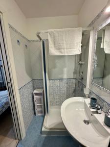 a bathroom with a sink and a shower at Cabina Da Mare in Marettimo
