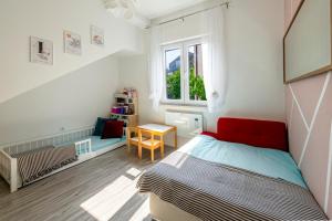 a small bedroom with a bed and a window at Villa Lucia in Mokošica