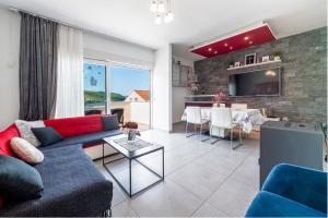 a living room with a couch and a table at Villa Lucia in Mokošica