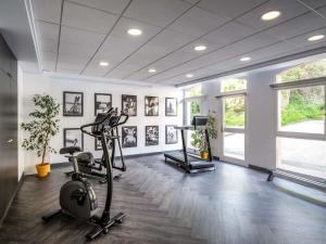 a gym with two exercise bikes in a room at Mercure Honfleur in Honfleur