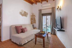 a living room with a couch and a tv and a table at Marbella Village in Marbella