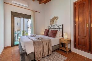 a bedroom with a large bed with a window at Marbella Village in Marbella