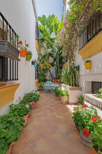 a courtyard with plants and flowers in a building at Marbella Village in Marbella +114 photos