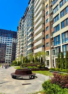 a sculpture in front of some tall buildings at Sea garden apartment in Kryzhanivka