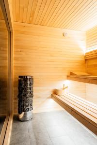 a sauna with a bench in a wooden room at Cichy Domek Karwia - Apartamenty - Basen, Jacuzzi, Sauna in Karwia +22 photos