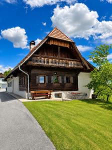 a wooden house with a bench in front of it at Winzerhaus am Eichberg in Leutschach
