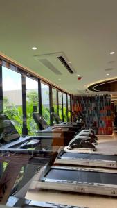a waiting room with chairs and tables and windows at The Rock Condo Central Phuket "Min-1 week" in Ban Rangeng