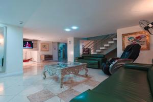 a living room with a couch and a table at Hotel Sagres Praia in Balneário Camboriú +1 photo