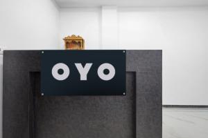 a sign on a wall with the ovo logo at Super Hotel O Antilia in Gorakhpur