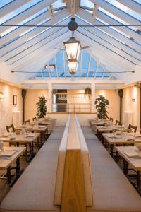 a large dining room with tables and a glass ceiling at The General Tarleton in Knaresborough