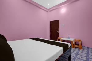 a bedroom with a white bed and a table at Hotel O A2Z Hotel in Lucknow