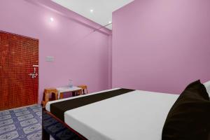 a bedroom with a large bed and a shower at Hotel O A2Z Hotel in Lucknow