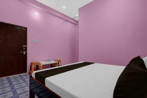 a bedroom with a white bed and a table at Hotel O A2Z Hotel in Lucknow +50 photos