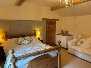 a bedroom with a bed and a chair in it at Southview Farm, Hambleton, Poulton-Le-Fylde in Hambleton