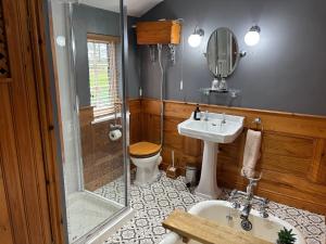 a bathroom with a shower and a sink and a toilet at Southview Farm, Hambleton, Poulton-Le-Fylde in Hambleton +38 photos
